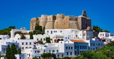 The streets of Chora and the iconic Monastery of Saint John the Theologian, Patmos island, Greece. (Shutterstock Photo)