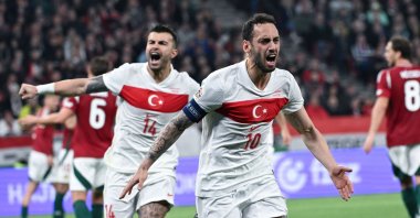 Türkiye&#039;s Hakan Çalhanoğlu (R) celebrates with teammate Abdülkerim Bardakçı after he scored a goal during the UEFA Nations League Division A playoff second leg match against Hungary at Puskas Arena, Budapest, Hungary, March 23, 2025. (EPA Photo)