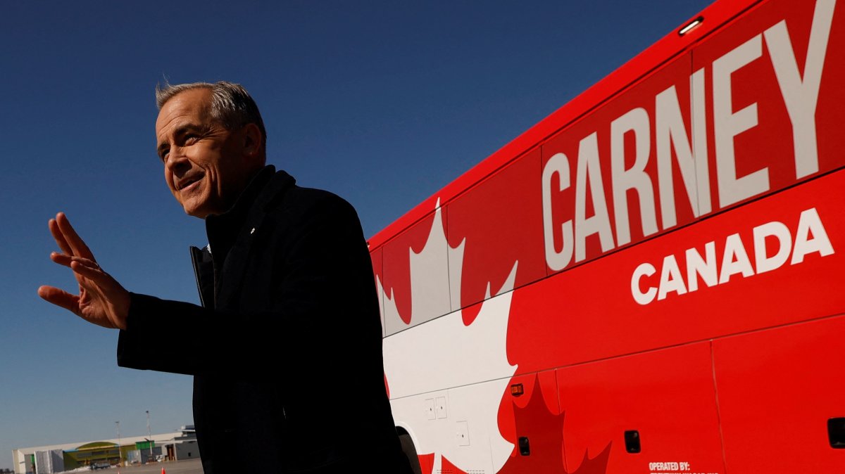 Canada&#039;s Prime Minister Mark Carney gestures before boarding an aircraft after calling for an election, Ottawa, Canada March 23, 2025. (Reuters Photo)