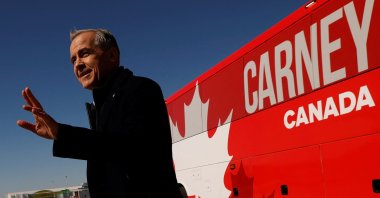 Canada's Prime Minister Mark Carney gestures before boarding an aircraft after calling for an election, Ottawa, Canada March 23, 2025. (Reuters Photo)
