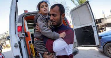 A man carries a child out of an ambulance after arriving from Jabalia at the Indonesian hospital in Beit Lahia in the northern Gaza Strip, Palestine, March 24, 2025. (AFP Photo)