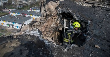 A firefighter works at a building hit by a Russian drone strike, in Kyiv, Ukraine, March 23, 2025. (Reuters Photo)