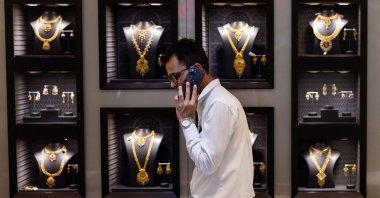 An employee walks past gold necklaces at a jewelry store, Mumbai, India, March 20, 2025. (Reuters Photo)