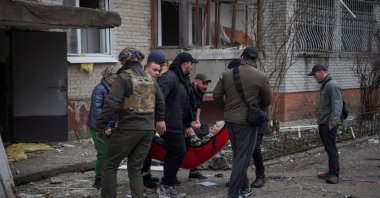 Rescuers and volunteers evacuate a wounded person from an apartment building damaged during a Russian missile strike, amid Russia's attack on Ukraine, Sumy, Ukraine, March 24, 2025. (Reuters Photo)