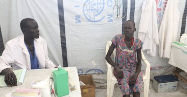 A lab technician James Khor, treats a patient at his private clinic, which is right across from the cholera center set up by Doctors Without Borders, Pieri, South Sudan, June 27, 2017. (AP Photo)