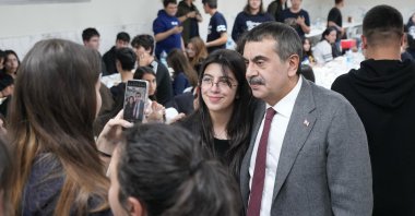 Education Minister Yusuf Tekin poses with a student during an iftar program at a high schoolö Ankara, Türkiye, March 20, 2025. (AA Photo)