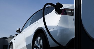 A Tesla car is being charged at an electric vehicle charging station at a shopping center car park, Wildau, Germany, March 20, 2024. (Reuters Photo)