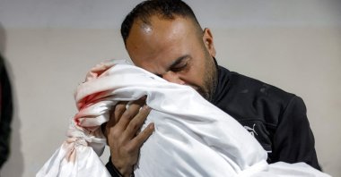 The father of young victim Ibtissam Elyan cradles the body of his daughter who was killed with other victims from the Elyan family earlier in Israeli bombardment on their house in Beit Lahia in the northern Gaza Strip, at the Indonesian Hospital, Beit Lahia, Palestine, March 25, 2025. (AFP Photo)