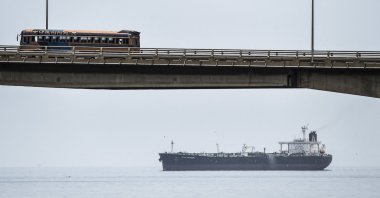 A bus drives over the General Rafael Urdaneta Bridge as an oil tanker sails across Maracaibo Lake, Maracaibo, Venezuela, March 15, 2019. (AFP Photo)