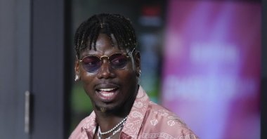 Paul Pogba stands in a VIP suite at the start of an MLS match between Inter Miami and Charlotte FC, Fort Lauderdale, U.S., Sept. 28, 2024. (AP Photo)
