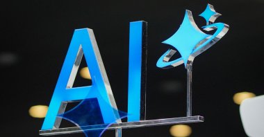 An AI sign is displayed during the Mobile World Congress  (MWC), the world's biggest mobile fair, in Barcelona, Spain, March 3, 2025. (AFP photo)