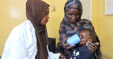 A mother feeds her child, who is suffering from malnutrition, next to a doctor in Khartoum, Sudan, March 15, 2025. (Reuters Photo)