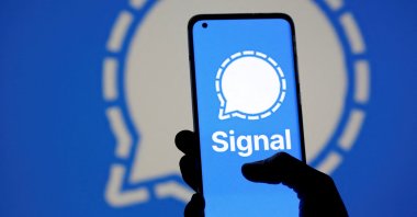 The Signal messaging app logo is seen on a smartphone, in front of the same displayed logo, in this illustration taken Jan. 13, 2021. (Reuters Photo)