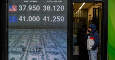 A man stands next to a currency exchange office, Istanbul, Türkiye, March 20, 2025. (AFP Photo)