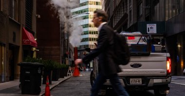 People walk through the Financial District near the New York Stock Exchange, New York City, U.S., March 19, 2025. (AFP Photo)