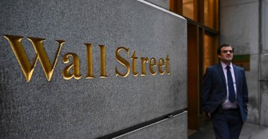 A person walks near the New York Stock Exchange (NYSE) on Wall Street in New York City, U.S., March 17, 2025. (AFP Photo)