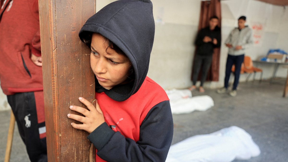 A child stands near the bodies of Palestinians killed in Israeli strikes, at Al-Ahli Arab Baptist hospital, in Gaza City, central Gaza, Palestine, March 26, 2025. (Reuters Photo)