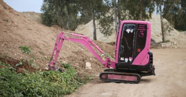 The father, Bedir Çakmak, drives his pink excavator, Didim, Aydın, western Türkiye, March 26, 2025. (AA Photo)