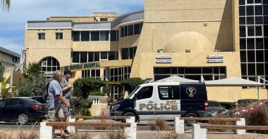 People walk next to an Egyptian police vehicle in front of the hospital where the bodies of foreigners killed when a tourist submarine sank off Egypt&#039;s Red Sea coast are kept in Hurghada, Egypt, March 27, 2025. (Reuters Photo)