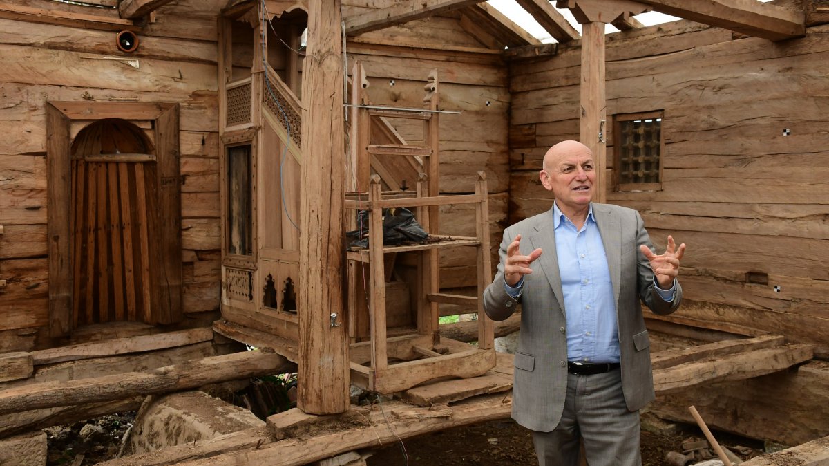 Terme Mayor Şenol Kul gives information about the restoration works on the historic wooden mosque, Terme, Samsun, northern Türkiye, March 27, 2025. (AA Photo)