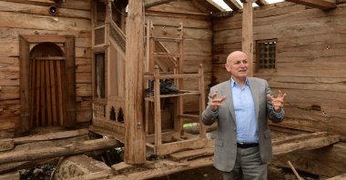 Terme Mayor Şenol Kul gives information about the restoration works on the historic wooden mosque, Terme, Samsun, northern Türkiye, March 27, 2025. (AA Photo)