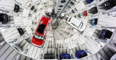 New Volkswagen cars float to vacant lots inside the sales tower of the VW Autostadt in Wolfsburg, Germany, March 11, 2025. (EPA Photo)