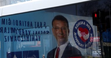 A billboard with a picture of Istanbul Mayor Ekrem Imamoğlu is reflected on a bus window the day he was jailed as part of a corruption investigation, Istanbul, Türkiye, March 23, 2025. (Reuters Photo)