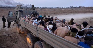 Israeli soldiers stand by a truck packed with bound and blindfolded Palestinian detainees, Gaza Strip, Palestine, Dec. 8, 2023. (AP Photo)