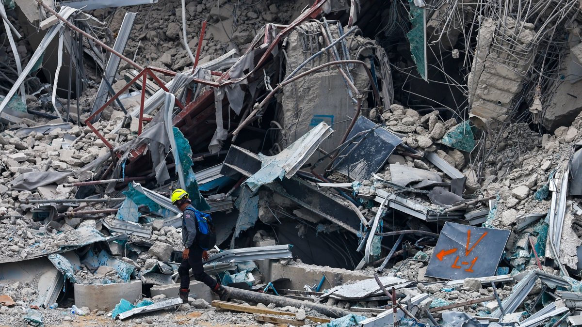 Rescue workers conduct a search operation for survivors at the site of a collapsed building, following an earthquake, Bangkok, Thailand, March 29, 2025. (AA Photo)