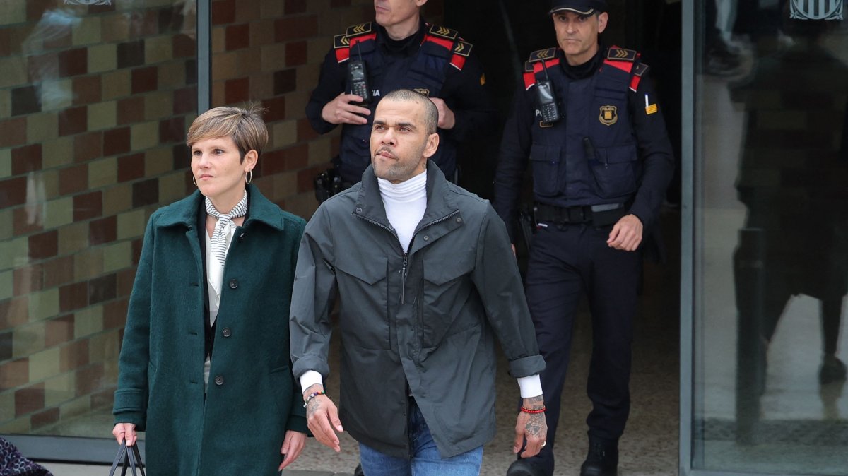 Convicted rapist and former Brazil international football player Dani Alves (R) leaves on provisional release, flanked by his lawyer Ines Guardiola, at Brians 2 prison in San Esteban Sasroviras, Barcelona, Spain, March 25, 2024. (AFP Photo)