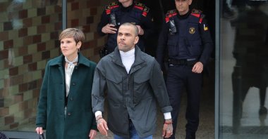 Convicted rapist and former Brazil international football player Dani Alves (R) leaves on provisional release, flanked by his lawyer Ines Guardiola, at Brians 2 prison in San Esteban Sasroviras, Barcelona, Spain, March 25, 2024. (AFP Photo)
