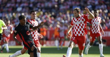Barcelona&#039;s Lamine Yamal (L) challenges for the ball with Girona&#039;s Miguel Gutierrez (C) and Girona&#039;s Daley Blind during the La Liga match at the Montilivi stadium, Girona, Spain, Sept. 15, 2024. (AP Photo)
