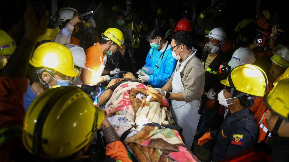Doctors and medical teams treat a victim trapped under the rubble of the destroyed Sky Villa Condominium development, Mandalay, Myanmar, March 30, 2025. (AFP Photo)