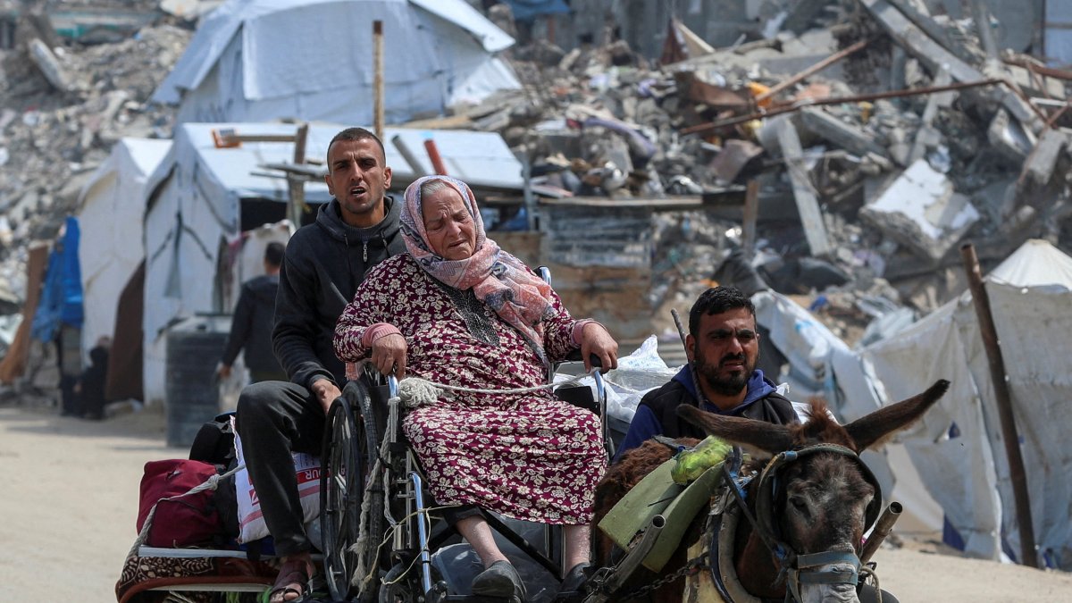 An old woman reacts as Palestinians make their way to flee their homes, after the Israeli army issued evacuation orders, Jabalia, Gaza Strip, Palestine, March 25, 2025. (Reuters Photo)
