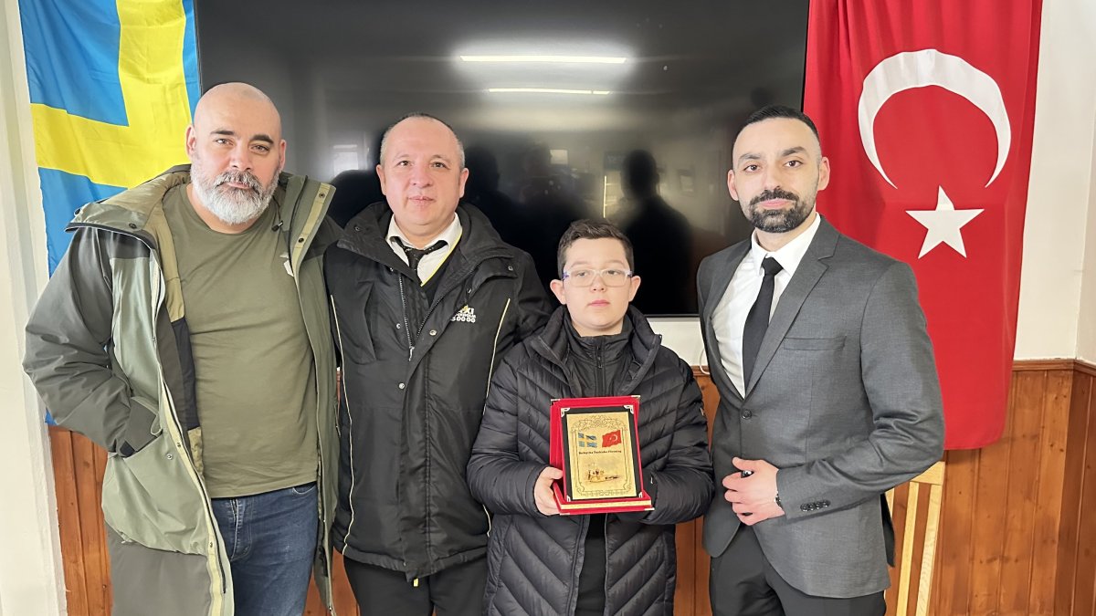 Uğur Ergün (right), head of the Stockholm Botkyrka Turkish Cultural Association, presents father and son with a plaque in recognition of their exemplary actions, in this photo released on Monday, March 31, 2025. (AA Photo)