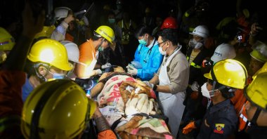 Doctors and medical teams treat a victim trapped under the rubble of the destroyed Sky Villa Condominium development, Mandalay, Myanmar, March 30, 2025. (AFP Photo)