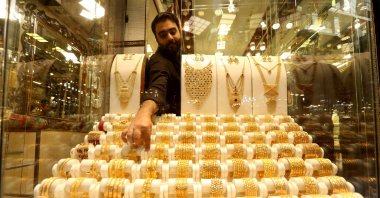 A goldsmith sells gold ornaments at a market in Peshawar, Pakistan, March 19, 2025. (EPA Photo)