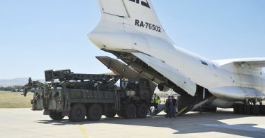 Military officials work around a Russian transport aircraft, carrying parts of the S-400 air defense systems, after it landed at Mürted military airport outside Ankara, Türkiye, Aug. 27, 2019. (AP Photo)