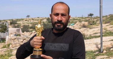 Palestinian filmmaker and Oscar winner for the documentary &quot;No Other Land&quot; Hamdan Ballal poses for a picture with his Oscar, as he recovers after Israeli settlers attacked him at home, occupied West Bank, Palestine, March 26, 2025. (AFP Photo)