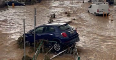 Stranded vehicles are seen in flood water in Naoussa, Paros island, Greece, March 31, 2025. (Retuers Photo)
