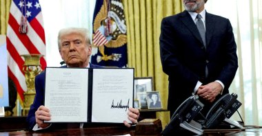 U.S. President Donald Trump holds an executive order about tariff increases, flanked by U.S. Commerce Secretary Howard Lutnick, in the White House, Washington D.C., U.S., Feb. 13, 2025. (Reuters Photo)
