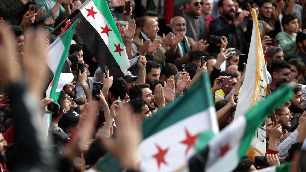 People wave flags as they gather in a square to commemorate the 10th anniversary of the taking of Idlib from the former regime leader Bashar Assad&#039;s army, Idlib, Syria, March 28, 2025. (AFP Photo)