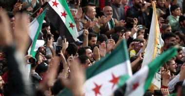 People wave flags as they gather in a square to commemorate the 10th anniversary of the taking of Idlib from the former regime leader Bashar Assad's army, Idlib, Syria, March 28, 2025. (AFP Photo)