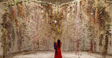 A visitor explores the &quot;Flowers - Flora in Contemporary Art &amp; Culture&quot; exhibition, London, U.K., Feb. 2, 2025. (Courtesy of Saatchi Gallery)