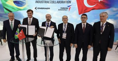Representatives of Turkish Aerospace Industries (TAI) and Brazil's Embraer sign a memorandum of understanding (MoU) at a defense expo, Brazil, April 1, 2025. (Courtesy of TUSAŞ)