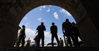 Members of Syria&#039;s security forces stand guard during the funeral of three people killed in Israeli strikes a day earlier, southern town of Daraa, Syria, March 18, 2025. (AFP Photo)