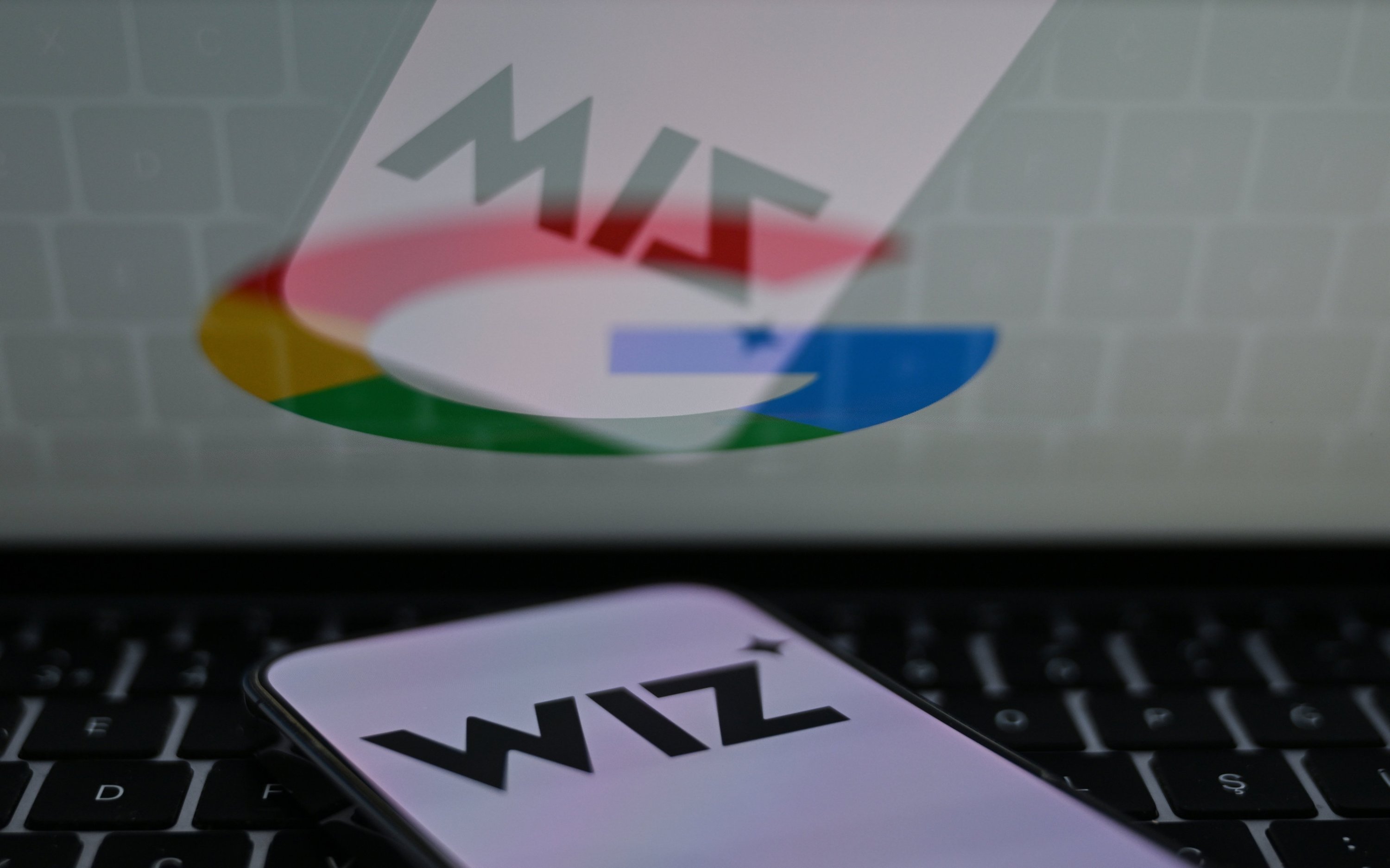 The logos of Google and Wiz are seen in this photo. (AA File Photo)