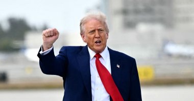 U.S. President Donald Trump pumps his fist upon arrival at Miami International Airport, Miami, U.S., April 3, 2025. (AFP Photo)