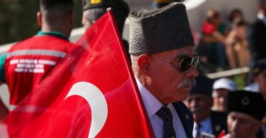 A man holds a Turkish flag during celebrations marking the 50th anniversary of Türkiye&#039;s intervention in the conflict in Cyprus, Lefkoşa (Nicosia), TRNC, July 20, 2024. (Getty Images)