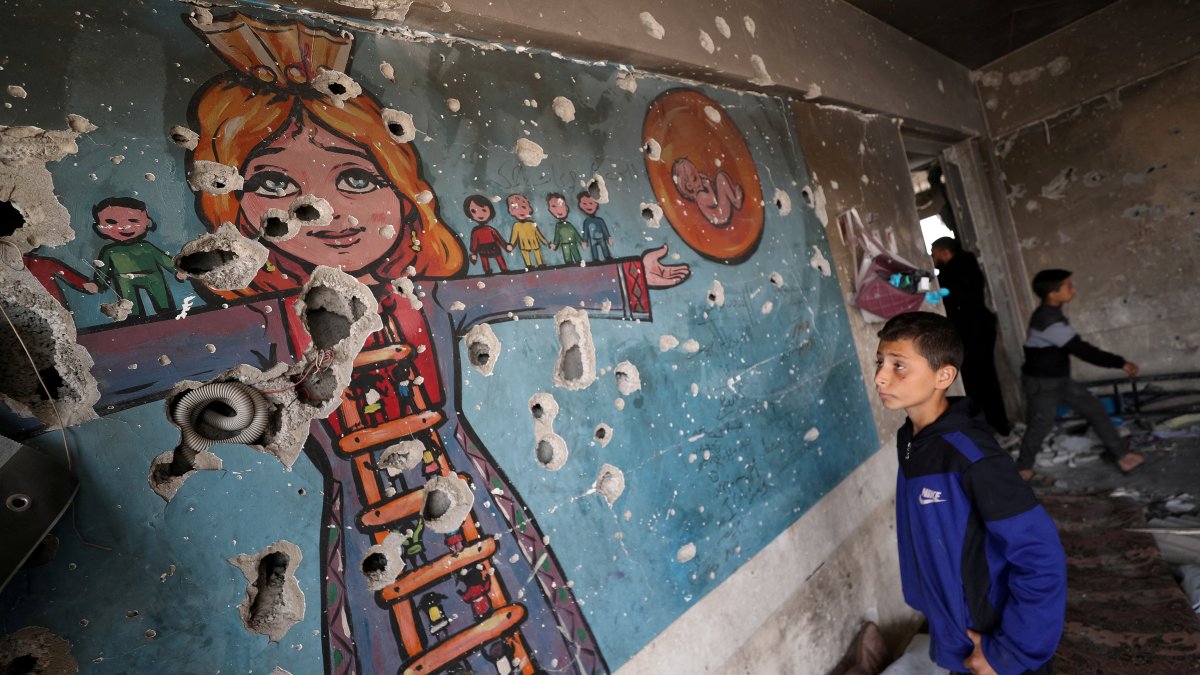 A boy looks at a damaged wall as Palestinians inspect the site of an Israeli airstrike on an UNRWA-run clinic where displaced people shelter, Jabalia, northern Gaza Strip, Palestine, April 2, 2025. (Reuters Photo)